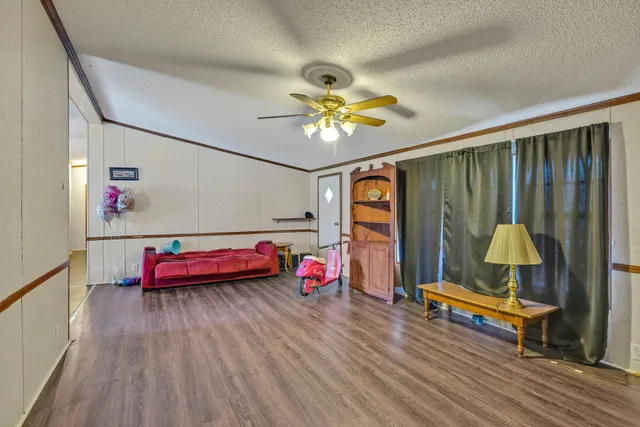 a living room with furniture a rug and a table