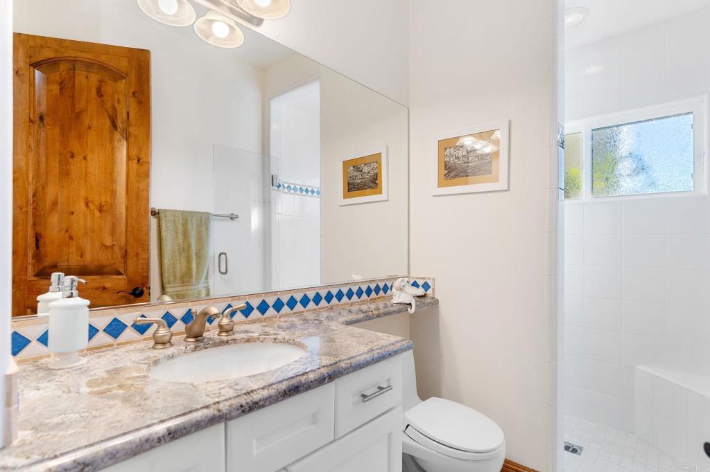 9746 Megan Escondido, CA 92026 - Photo 29 of 65 a bathroom with a granite countertop sink mirror vanity and toilet