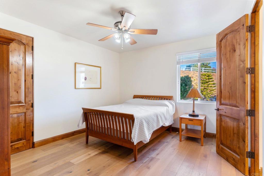 9746 Megan Escondido, CA 92026 - Photo 33 of 65 a bedroom with a bed and wooden floor