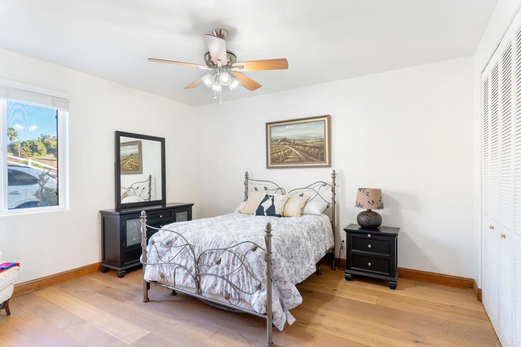 9746 Megan Escondido, CA 92026 - Photo 35 of 65 a bedroom with a bed and a chandelier