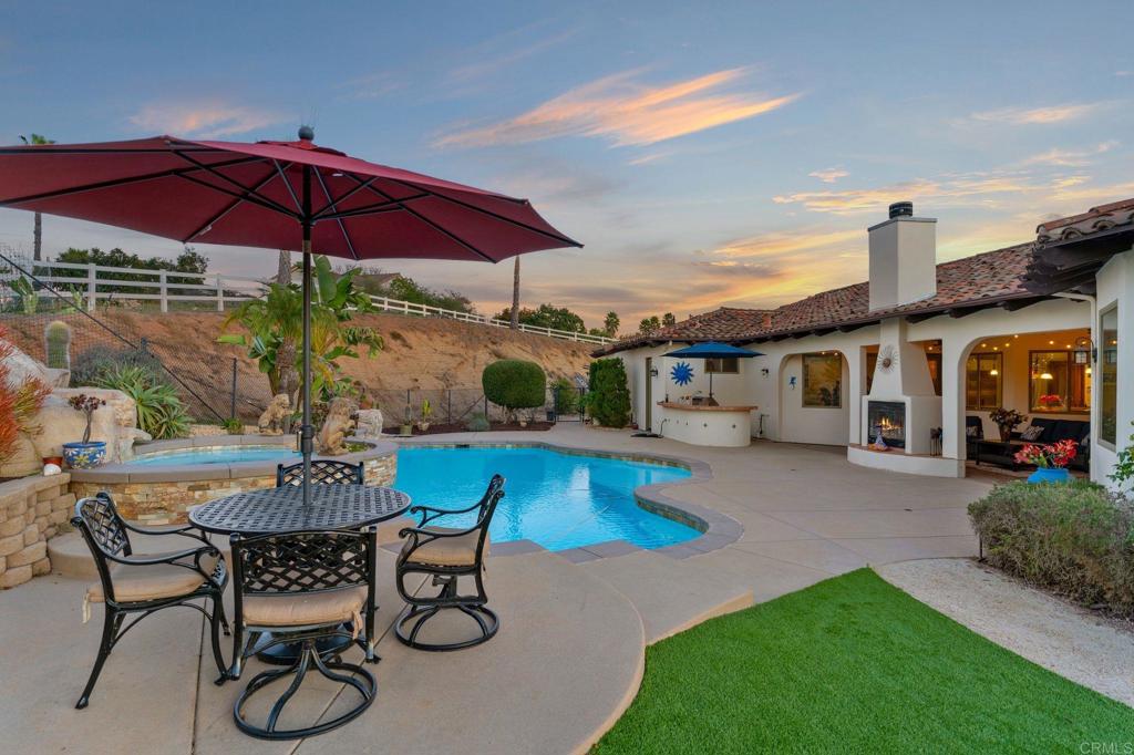 9746 Megan Escondido, CA 92026 - Photo 51 of 65 a patio with a table and chairs under an umbrella