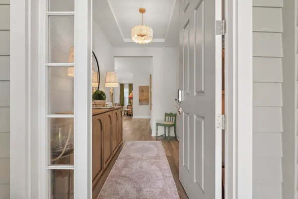 a view of hallway with wooden floor