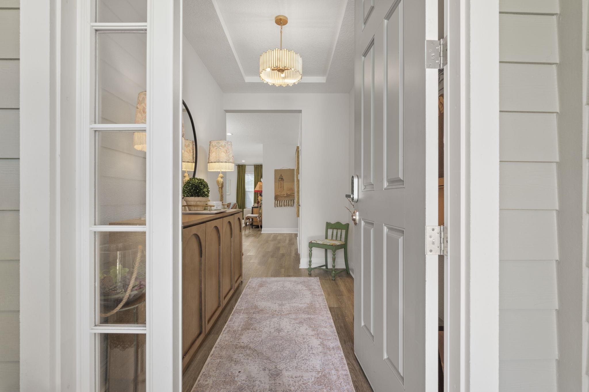 a view of hallway with wooden floor