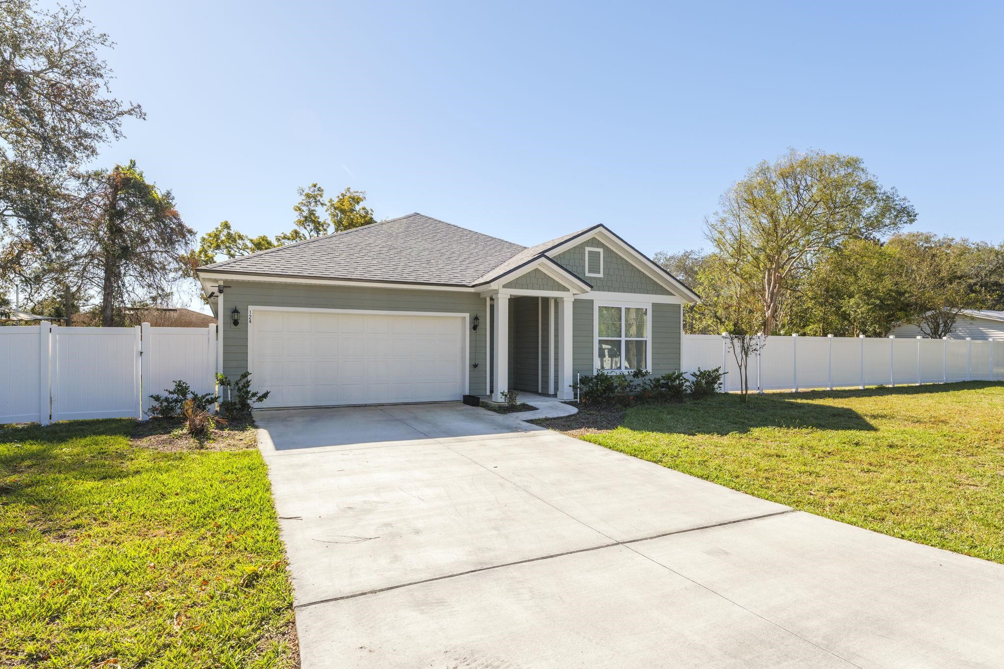 124 Swallow Road St. Augustine, FL 32086 - Photo 3 of 28 a front view of house with yard and garage