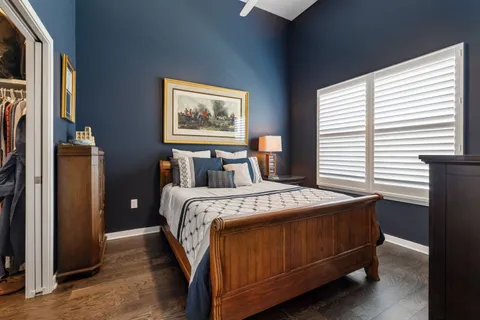 a bedroom with a bed and a dresser in it