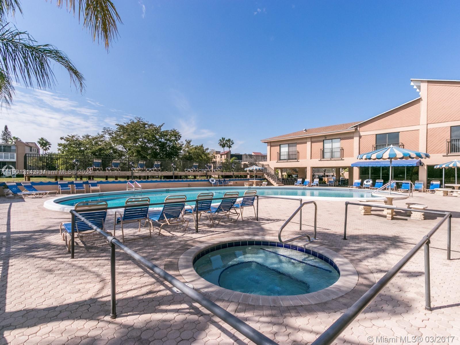 357 North Rock Island Road, Unit 304 Margate, FL 33063 - Photo 16 of 20 a swimming pool with outdoor seating and yard