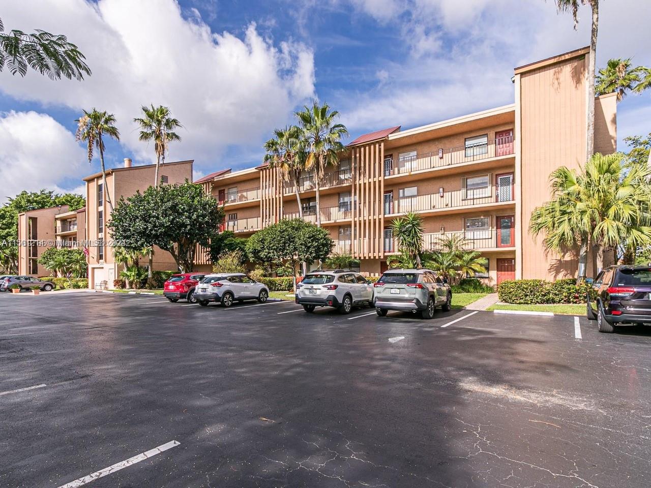 357 North Rock Island Road, Unit 304 Margate, FL 33063 - Photo 2 of 20 a view of a cars park in front of a building