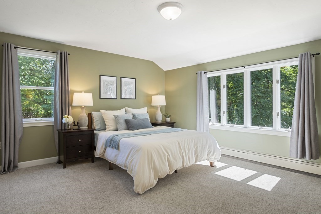 221 Red Acre Road Stow, MA 01775 - Photo 11 of 28 a spacious bedroom with a bed and a large window