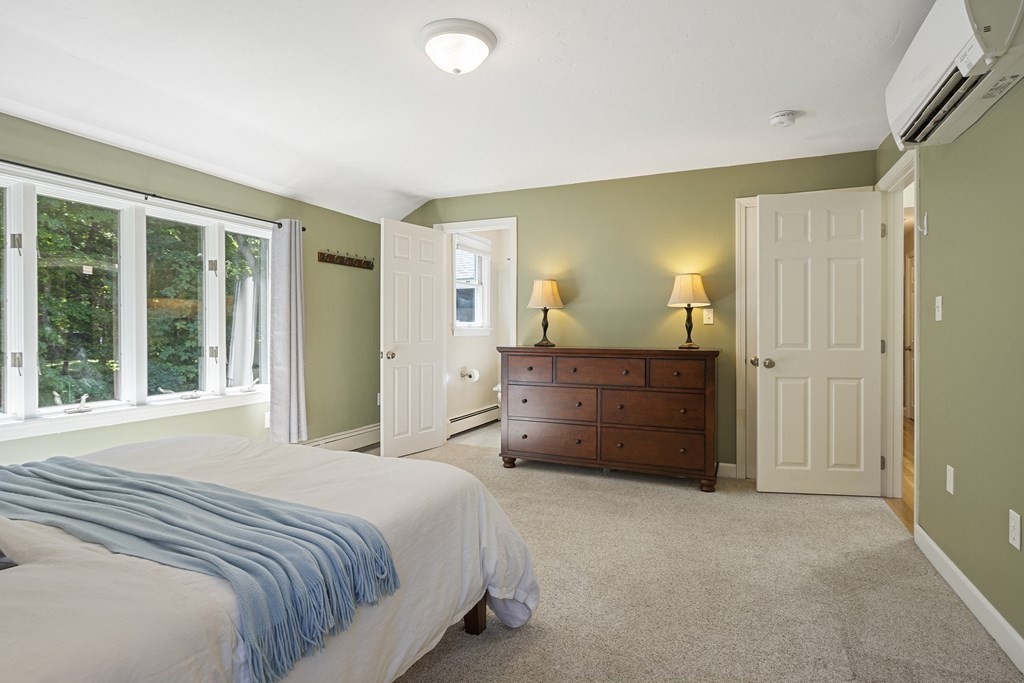 221 Red Acre Road Stow, MA 01775 - Photo 12 of 28 a spacious bedroom with a bed and a dresser