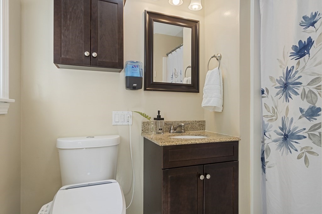 221 Red Acre Road Stow, MA 01775 - Photo 13 of 28 a bathroom with a toilet sink and mirror