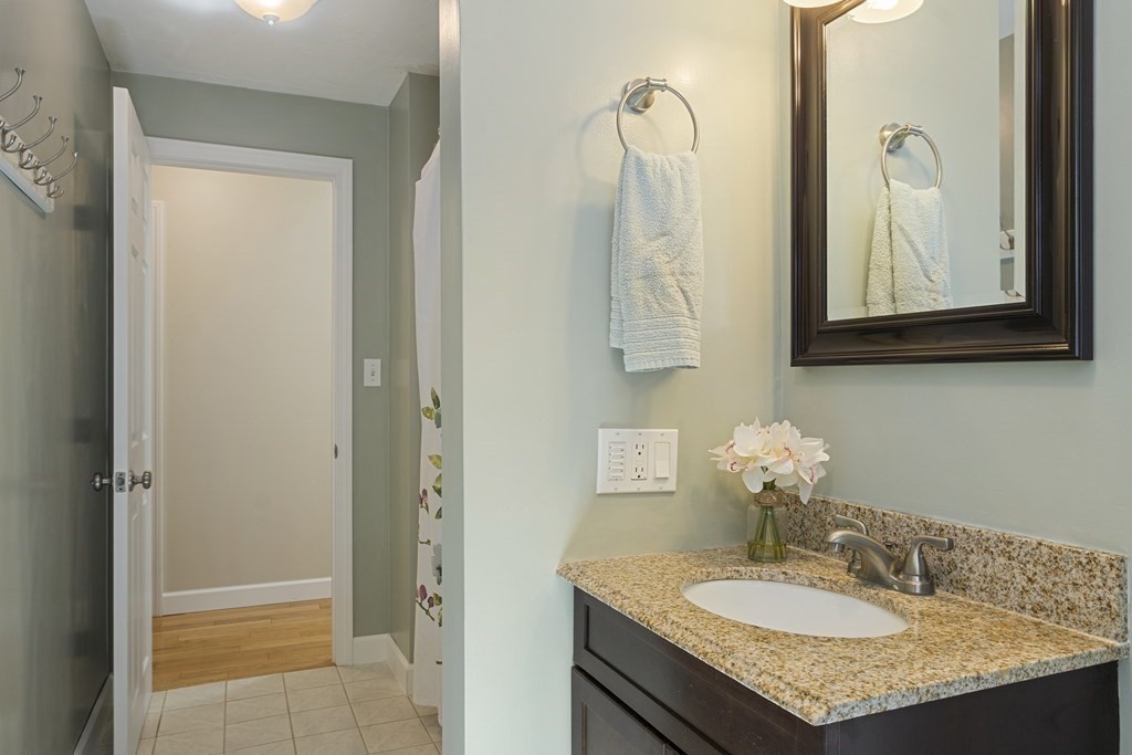 221 Red Acre Road Stow, MA 01775 - Photo 18 of 28 a bathroom with a granite countertop sink and a mirror