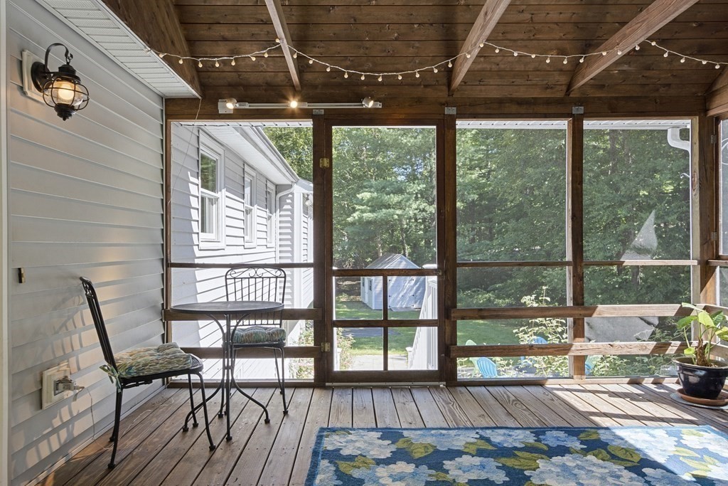 221 Red Acre Road Stow, MA 01775 - Photo 24 of 28 a view of a porch with furniture and wooden floor