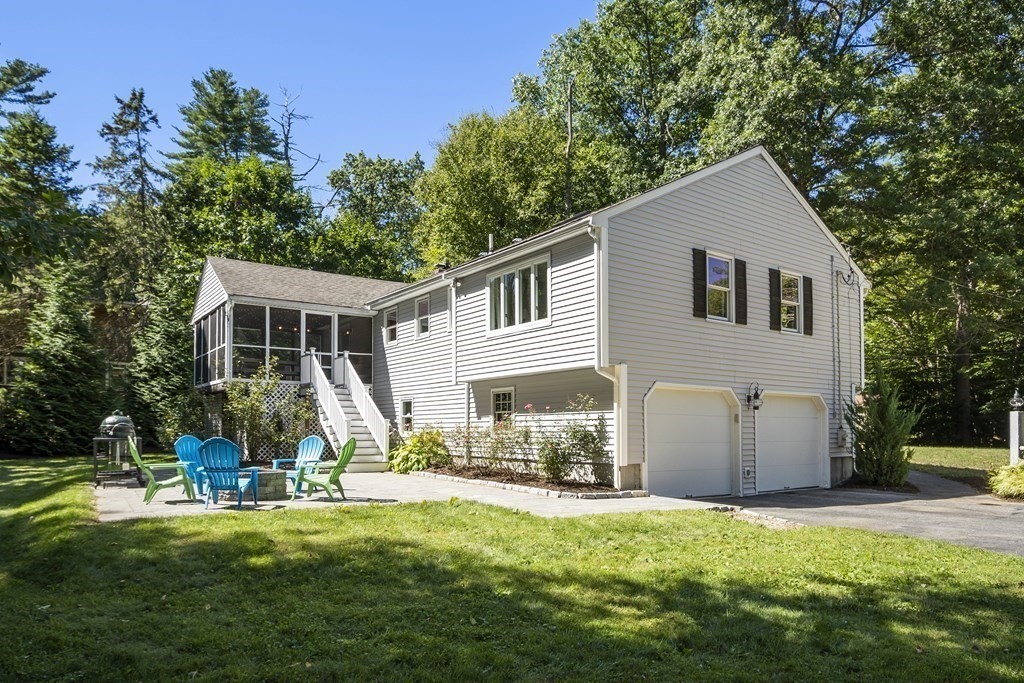 221 Red Acre Road Stow, MA 01775 - Photo 27 of 28 a view of a house with backyard and a tree