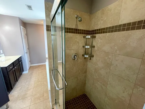 a bathroom with a shower and a sink