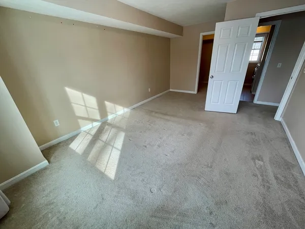 a view of an empty room with wooden door