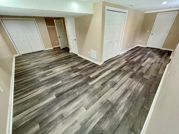 a view of a room with wooden floor