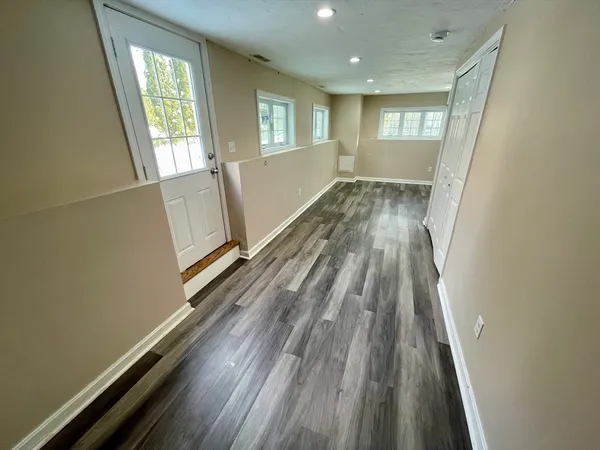 a view of a room with wooden floor and staircase