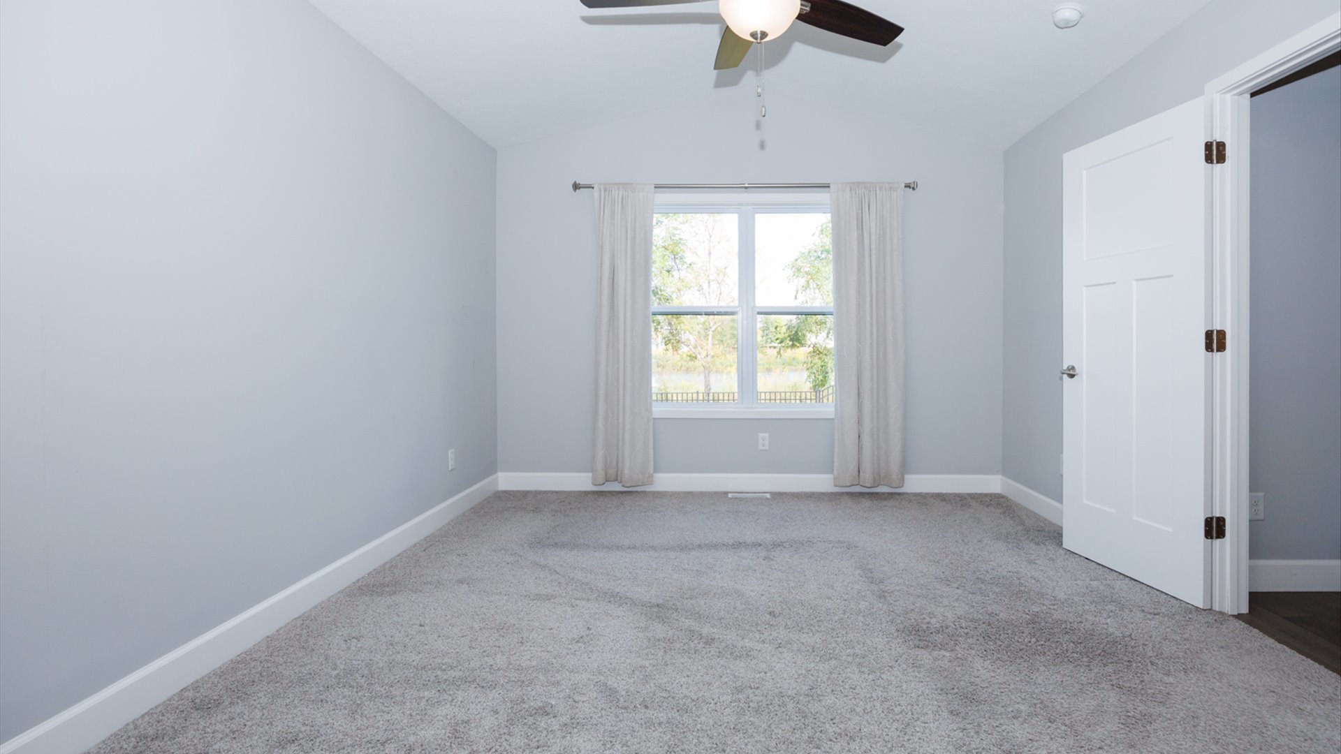 1104 Hershey Road Normal, IL 61761 - Photo 18 of 48 an empty room with a chandelier fan and windows