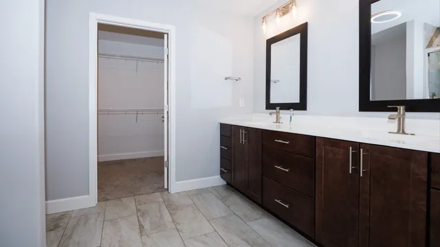 a bathroom with a double vanity sink and mirror