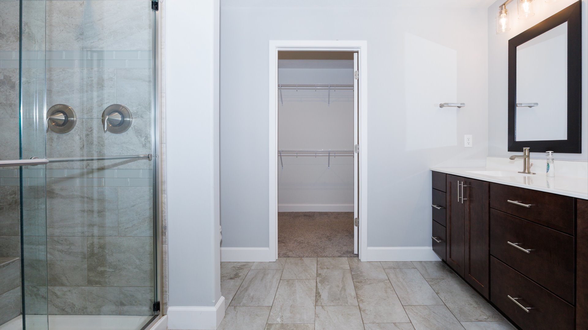 1104 Hershey Road Normal, IL 61761 - Photo 20 of 48 a bathroom with a double vanity sink a mirror and shower