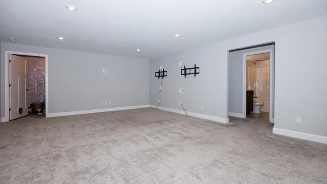 an empty room with closet and a hallway