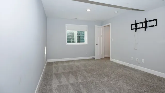 an empty room with windows and closet
