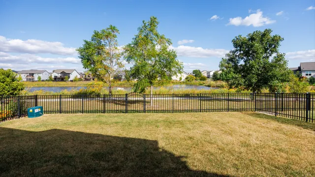 a view of swimming pool with outdoor seating and yard in back