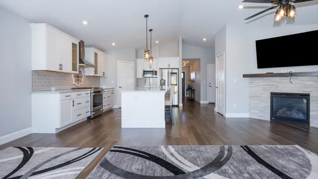 a living room with stainless steel appliances furniture or kitchen view and a fireplace