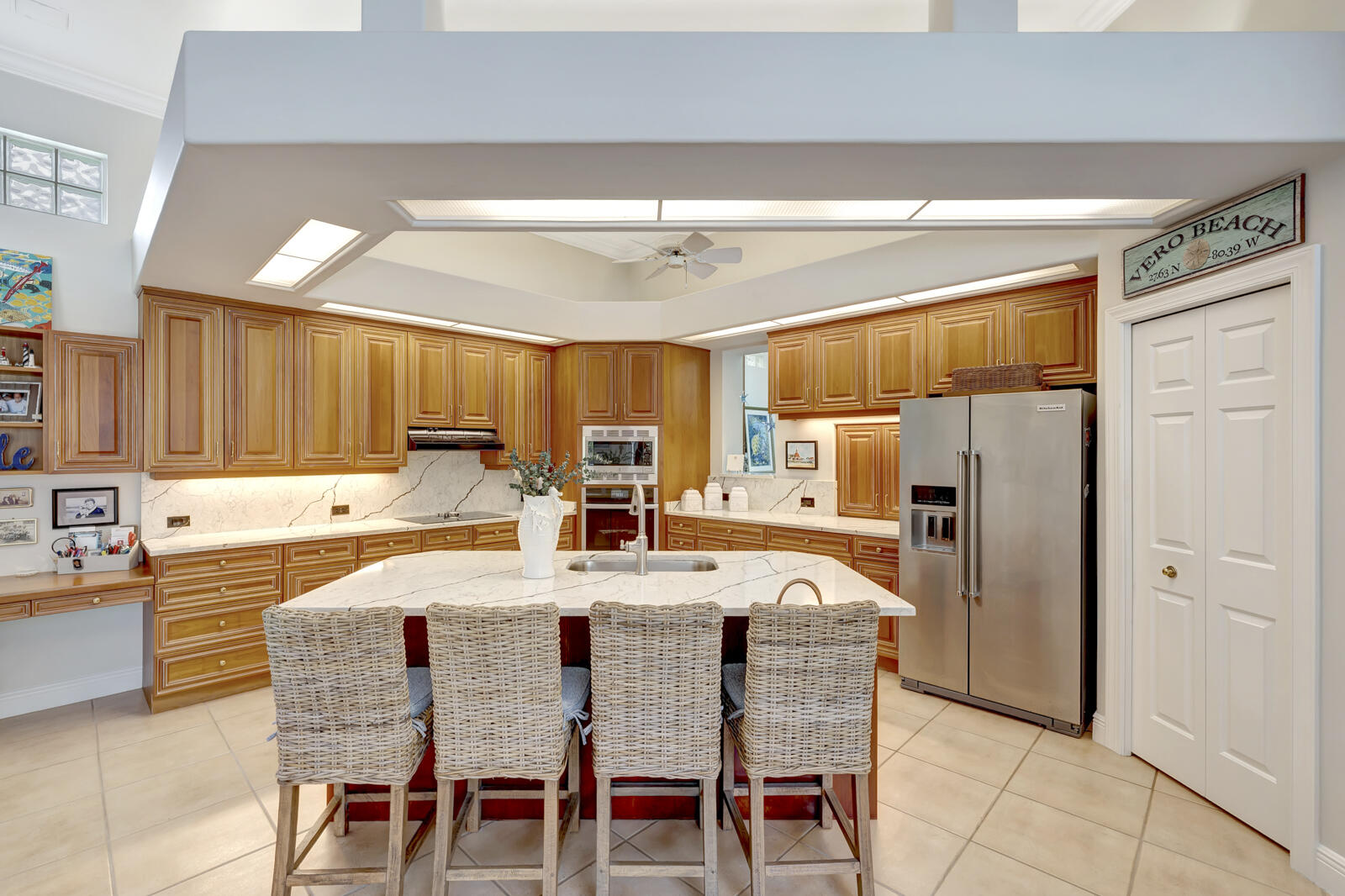 201 Seaside Pathway Vero Beach, FL 32963 - Photo 11 of 53 a kitchen with stainless steel appliances a refrigerator and a table