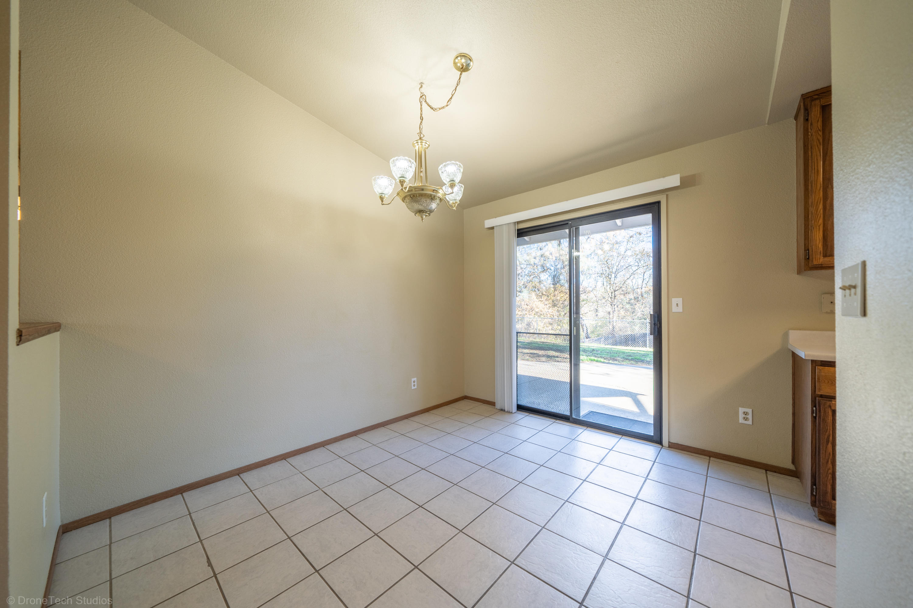 3645 Santa Rosa Way Redding, CA 96003 - Photo 11 of 48 a view of an empty room with window and chandelier