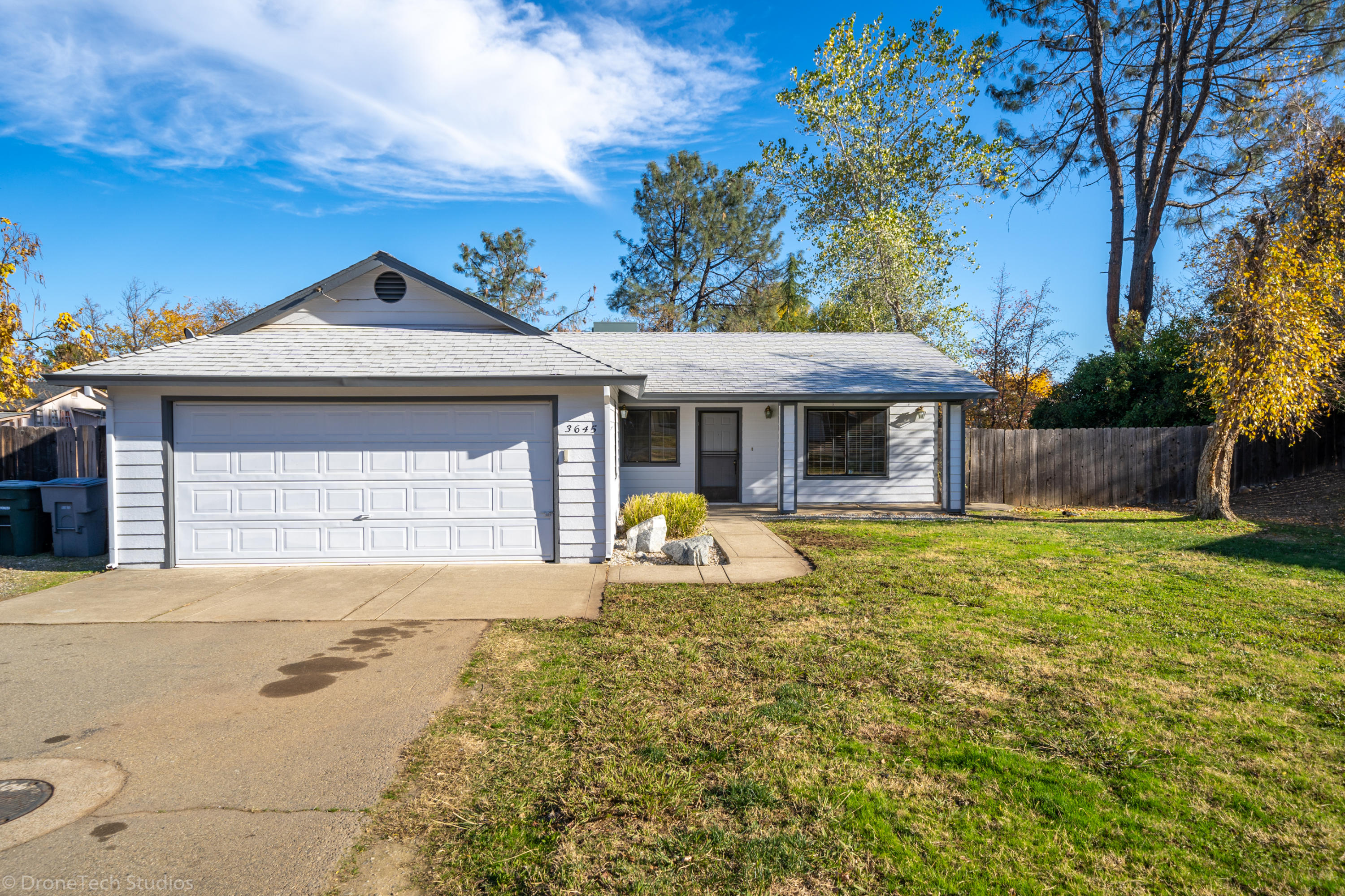 3645 Santa Rosa Way Redding, CA 96003 - Photo 2 of 48 a front view of a house with a garden and porch
