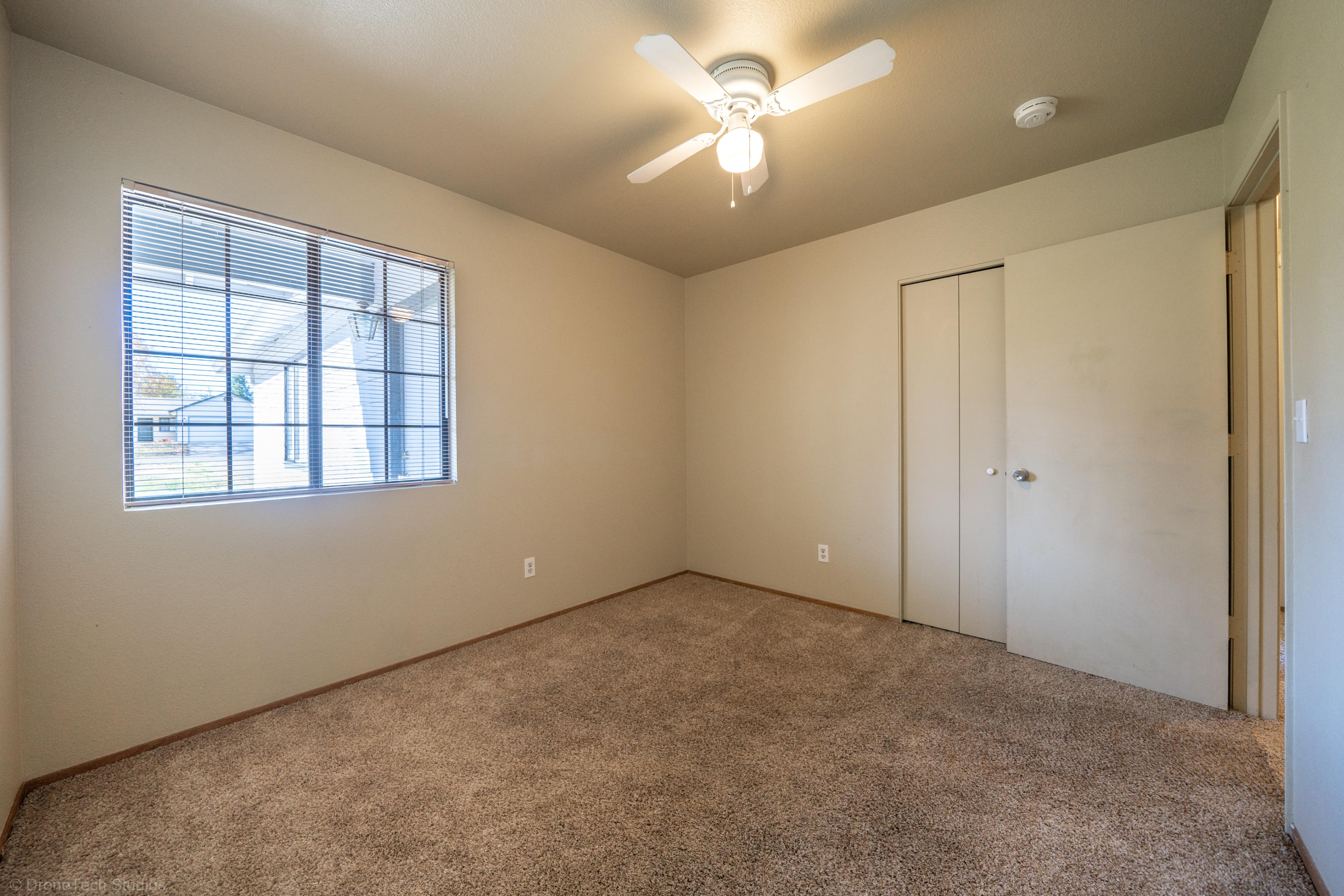 3645 Santa Rosa Way Redding, CA 96003 - Photo 26 of 48 an empty room with a ceiling fan and a window
