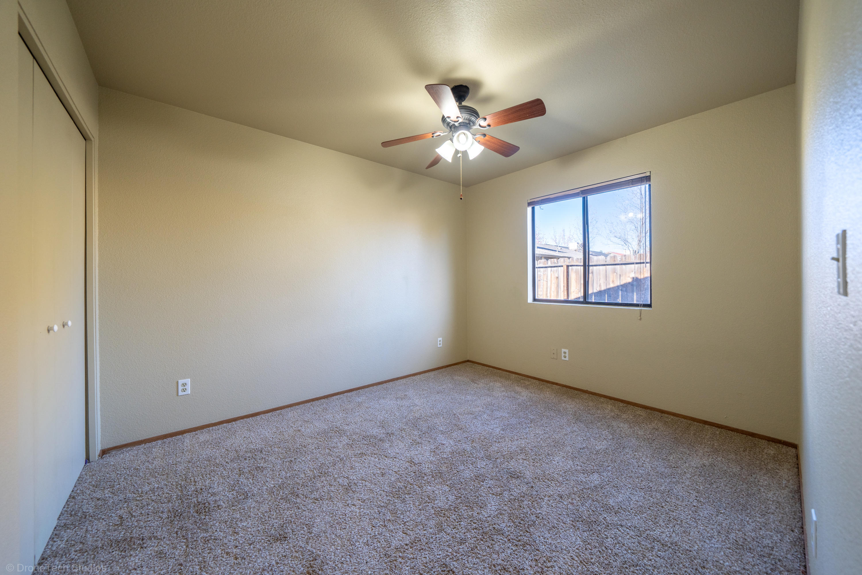 3645 Santa Rosa Way Redding, CA 96003 - Photo 27 of 48 an empty room with windows and fan