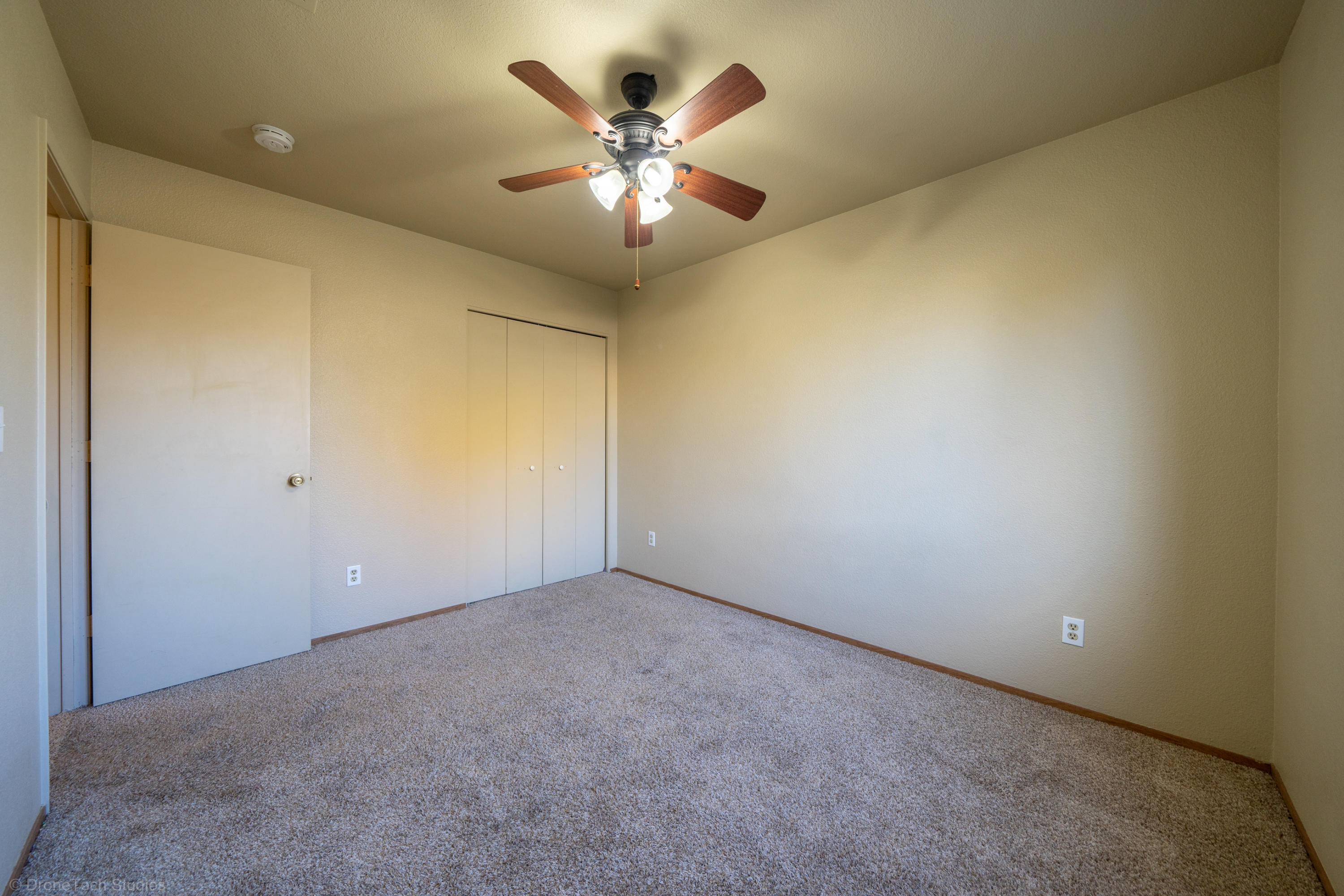 3645 Santa Rosa Way Redding, CA 96003 - Photo 28 of 48 an empty room with chandelier fan and windows