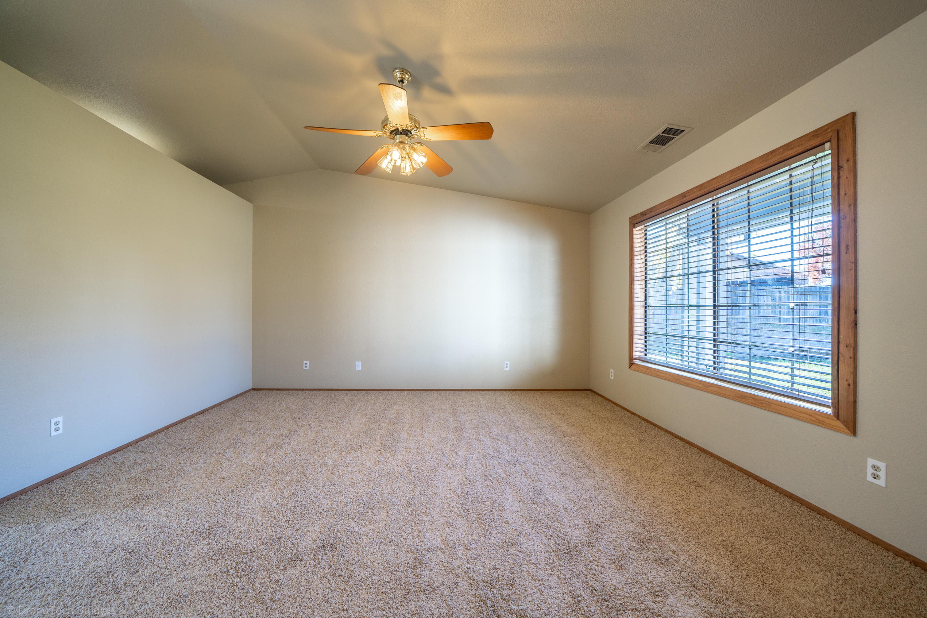 3645 Santa Rosa Way Redding, CA 96003 - Photo 6 of 48 an empty room with windows and fan
