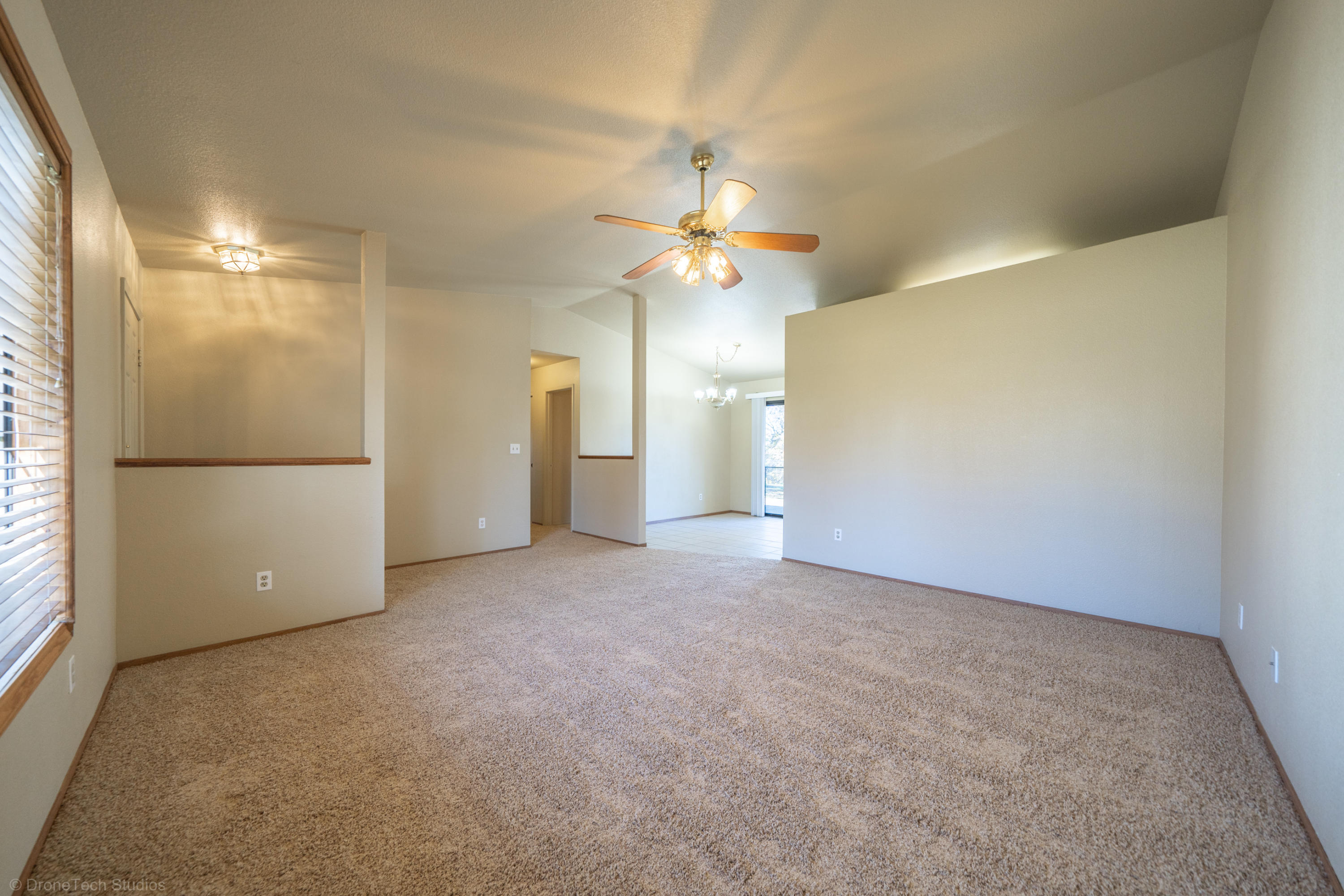 3645 Santa Rosa Way Redding, CA 96003 - Photo 9 of 48 a view of a big room with chandelier fan and windows