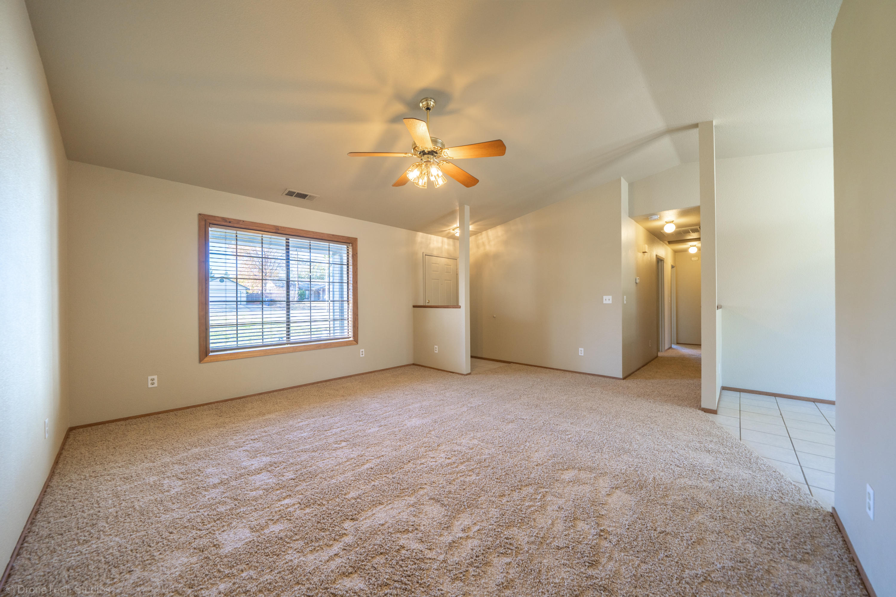 3645 Santa Rosa Way Redding, CA 96003 - Photo 10 of 48 an empty room with chandelier fan and windows