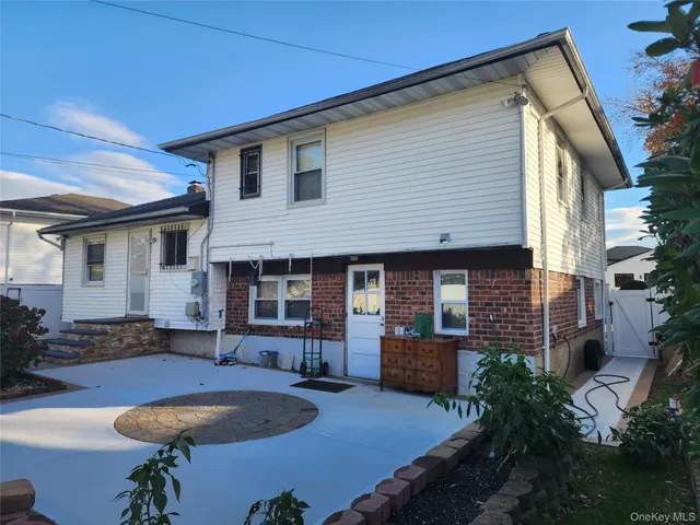 a front view of a house with yard and patio
