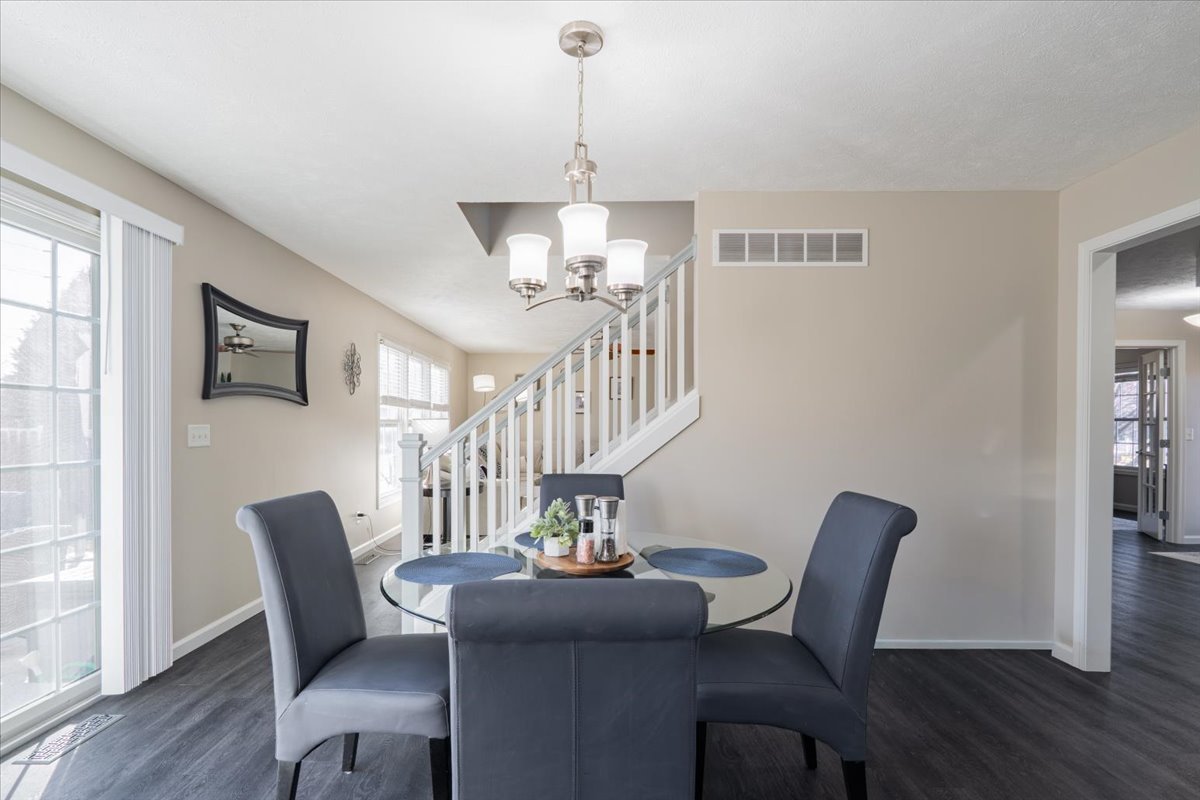 801 Balsam Road Normal, IL 61761 - Photo 12 of 56 a view of a dining room with furniture wooden floor and chandelier