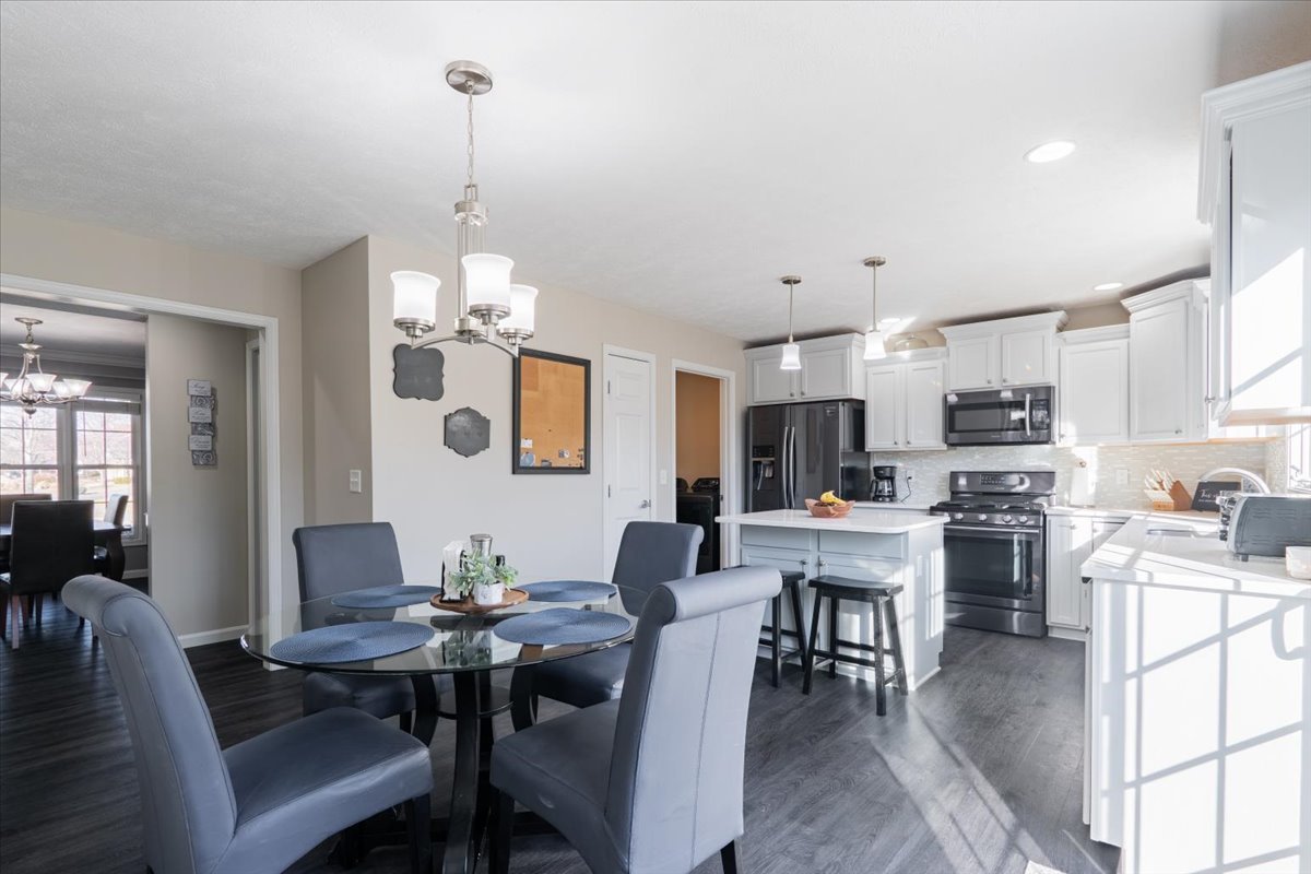 801 Balsam Road Normal, IL 61761 - Photo 13 of 56 a view of a dining room and livingroom furniture a rug a kitchen and a chandelier