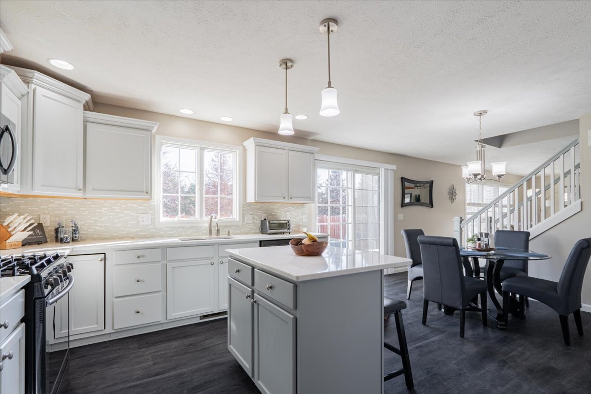 801 Balsam Road Normal, IL 61761 - Photo 15 of 56 a kitchen that has a lot of cabinets in it with a dining table and chairs
