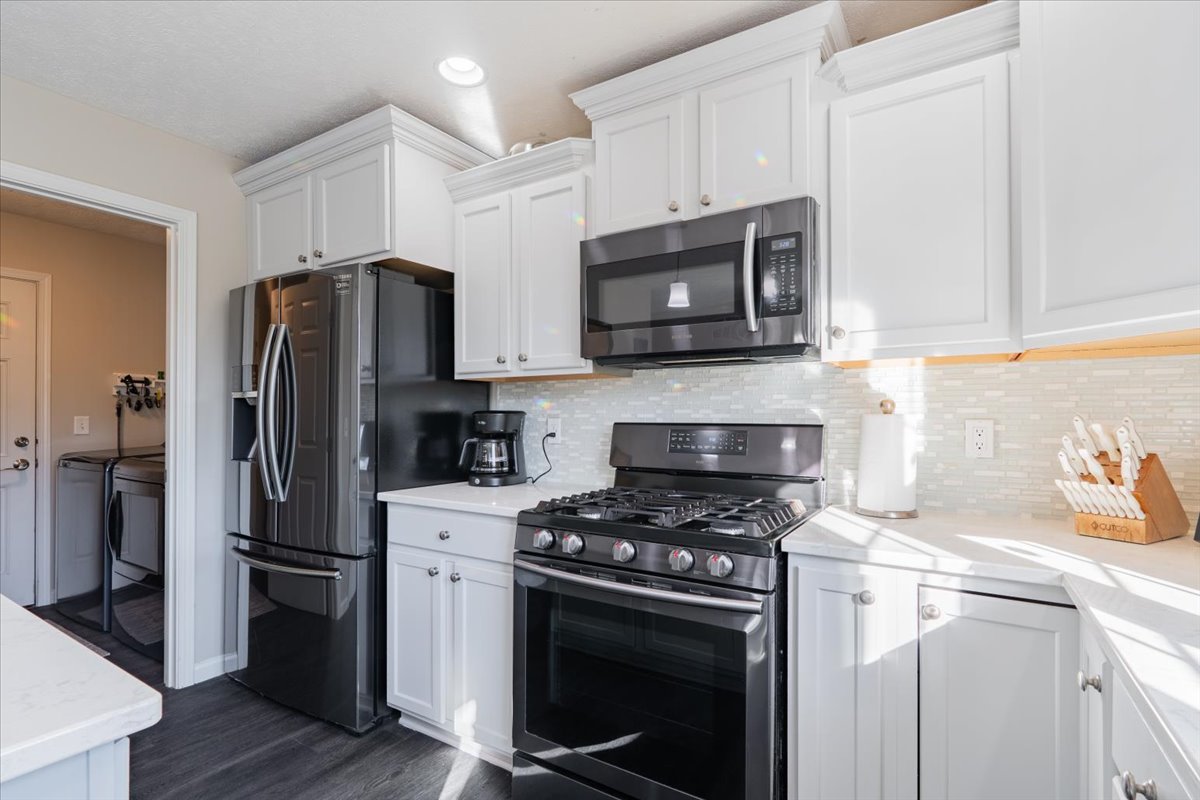 801 Balsam Road Normal, IL 61761 - Photo 17 of 56 a kitchen with stainless steel appliances white cabinets a stove a microwave a refrigerator a sink and cabinets