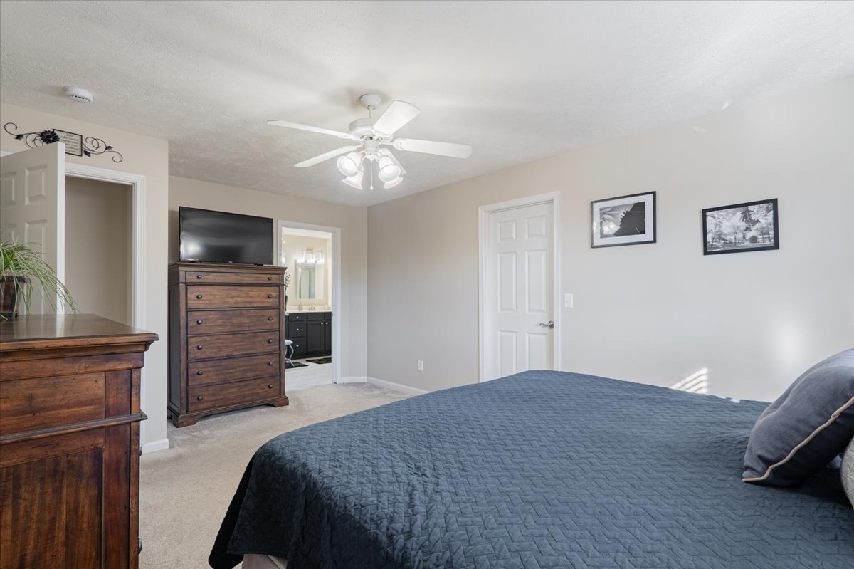 801 Balsam Road Normal, IL 61761 - Photo 21 of 56 a bedroom with a bed and a flat screen tv