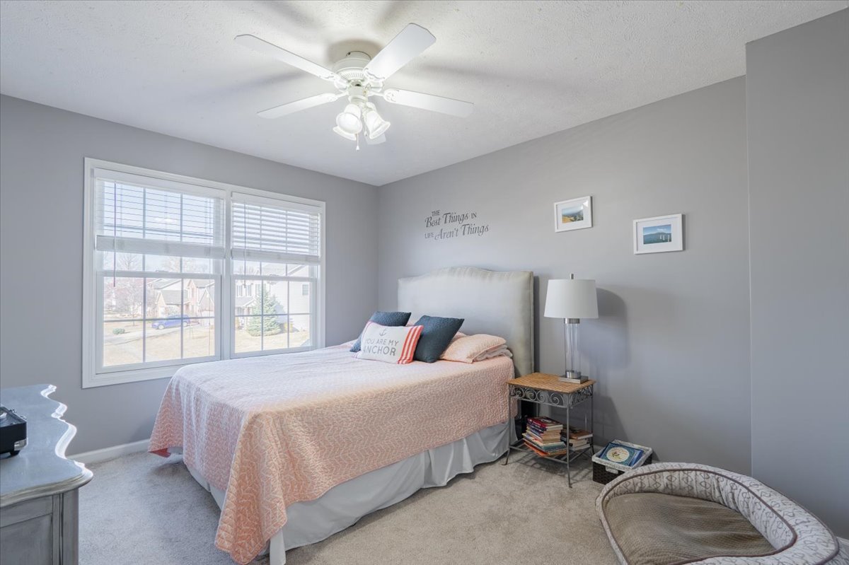 801 Balsam Road Normal, IL 61761 - Photo 25 of 56 a bedroom with a bed and a chandelier