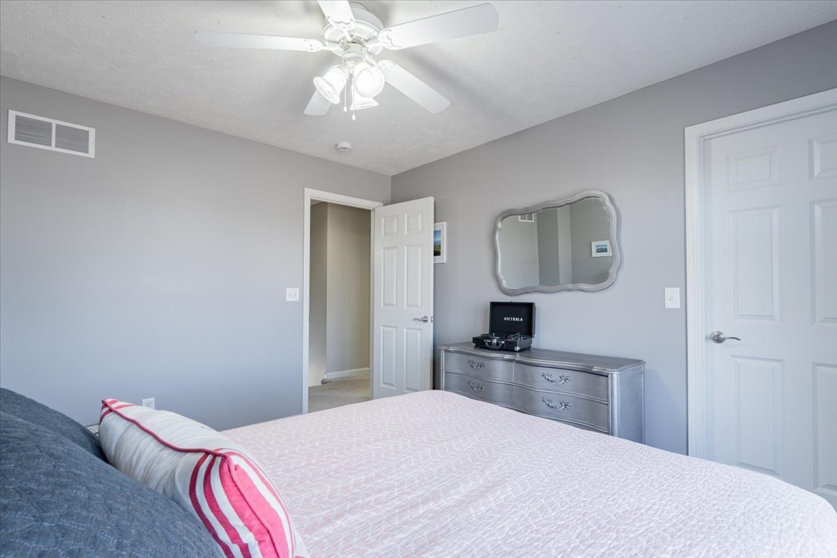 801 Balsam Road Normal, IL 61761 - Photo 26 of 56 a bedroom with a bed and a chandelier
