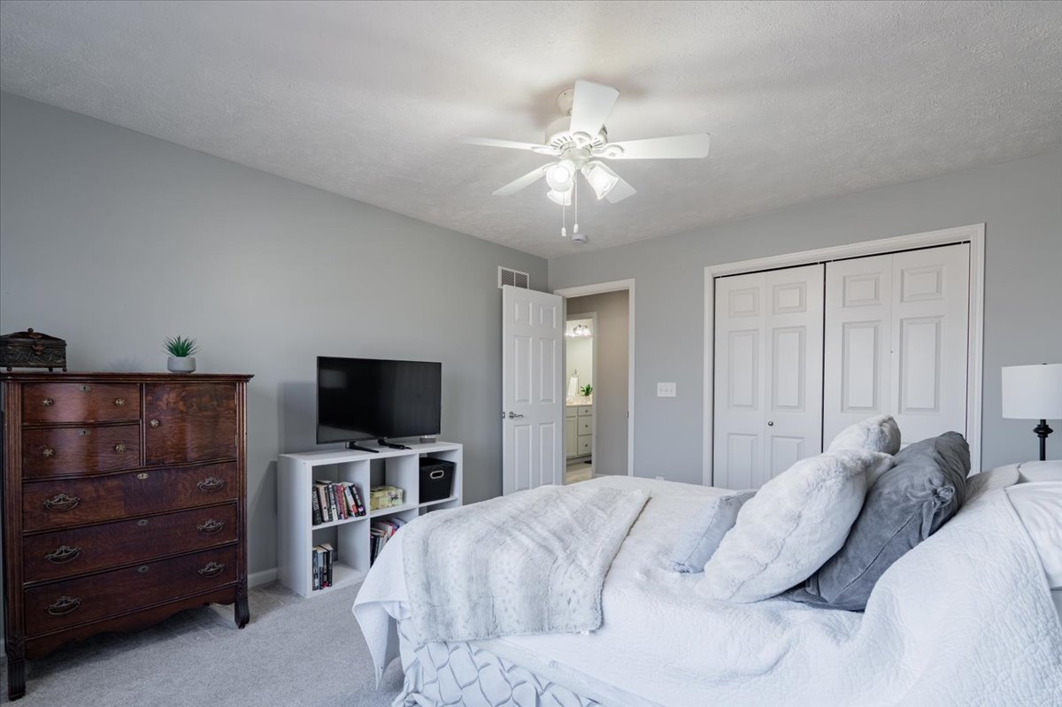 801 Balsam Road Normal, IL 61761 - Photo 29 of 56 a bedroom with a bed and a flat tv screen on dresser