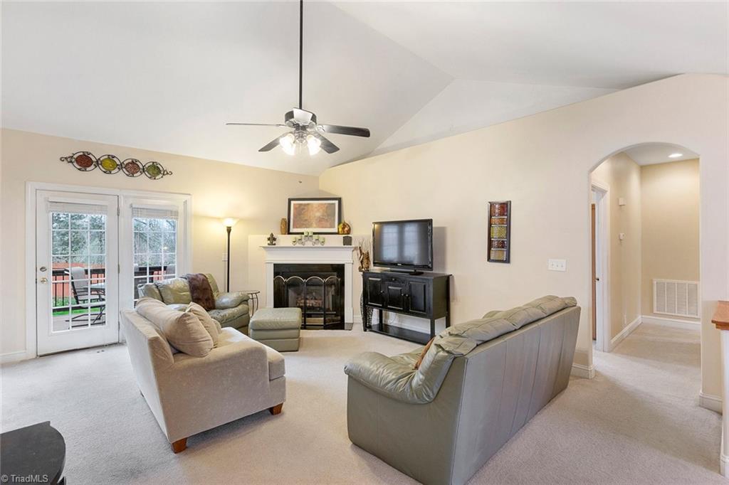 516 Beech Ridge Road Thomasville, NC 27360 - Photo 3 of 30 Enjoy an open living room with vaulted ceilings and a cozy gas log fireplace.