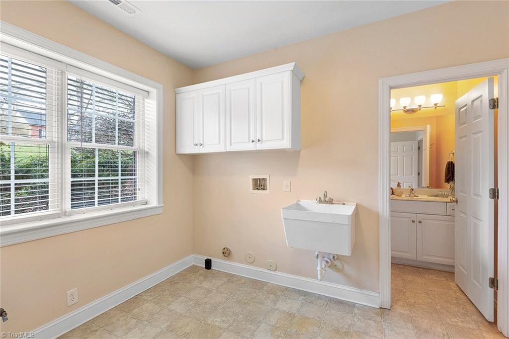 516 Beech Ridge Road Thomasville, NC 27360 - Photo 24 of 30 Large laundry room with storage and an utility sink.