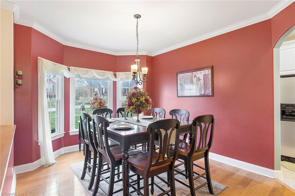 516 Beech Ridge Road Thomasville, NC 27360 - Photo 5 of 30 Formal dining room with lots of natural light from the beautiful bay window feature. Notice the hardwood floors and crown moulding.