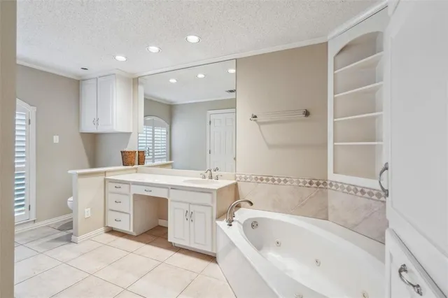 a bathroom with a bathtub sink and mirror